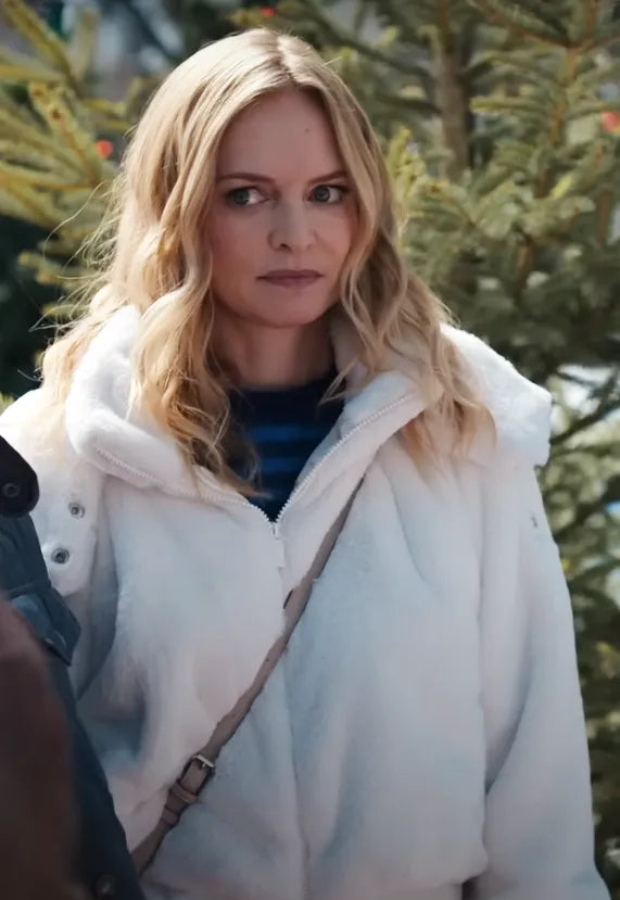 Woman in a white furry jacket outdoors by a pine tree, winter or Christmas setting