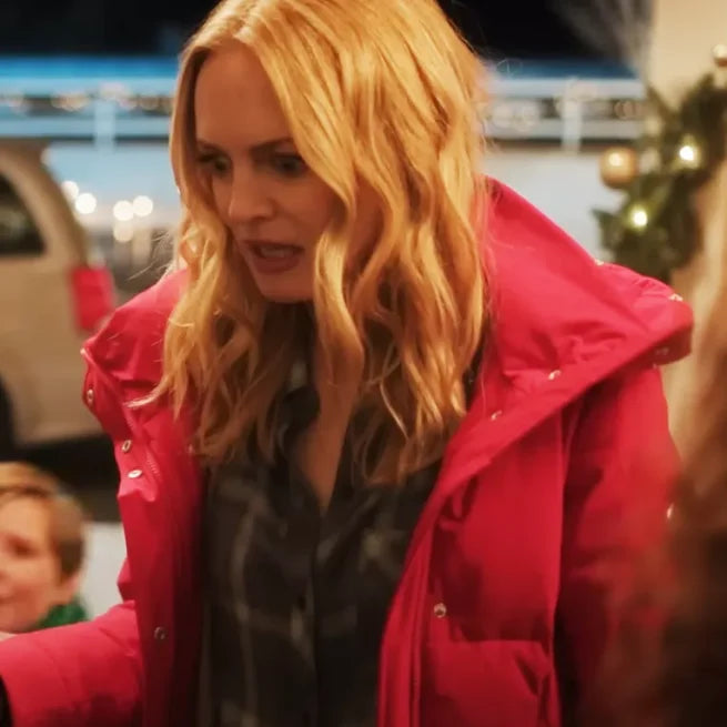 Woman in a red puffer jacket indoors, Christmas decorations and lights in background