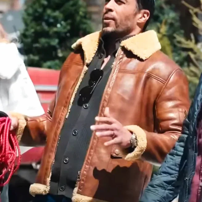 Man outdoors wearing brown shearling leather jacket, sunglasses, Christmas setting