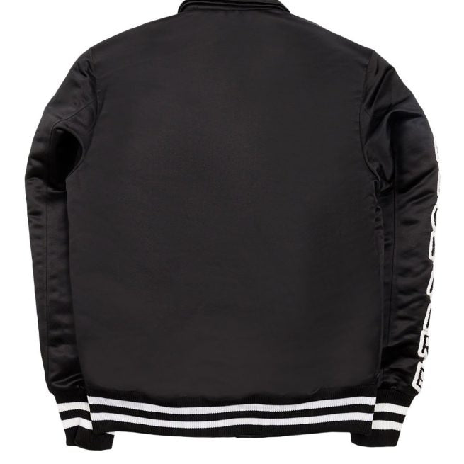 Black satin bomber jacket with white striped cuffs and lettering on sleeve