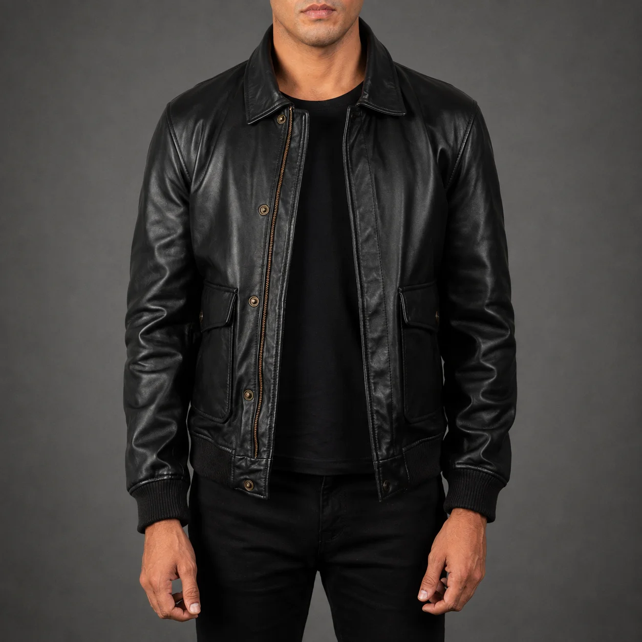 Men's Maddox A-2 black leather bomber jacket crafted from premium genuine leather featuring a classic A-2 flight silhouette, sleek black finish, ribbed cuffs and hem, durable construction, and timeless aviation-inspired style by Jonny N Guys