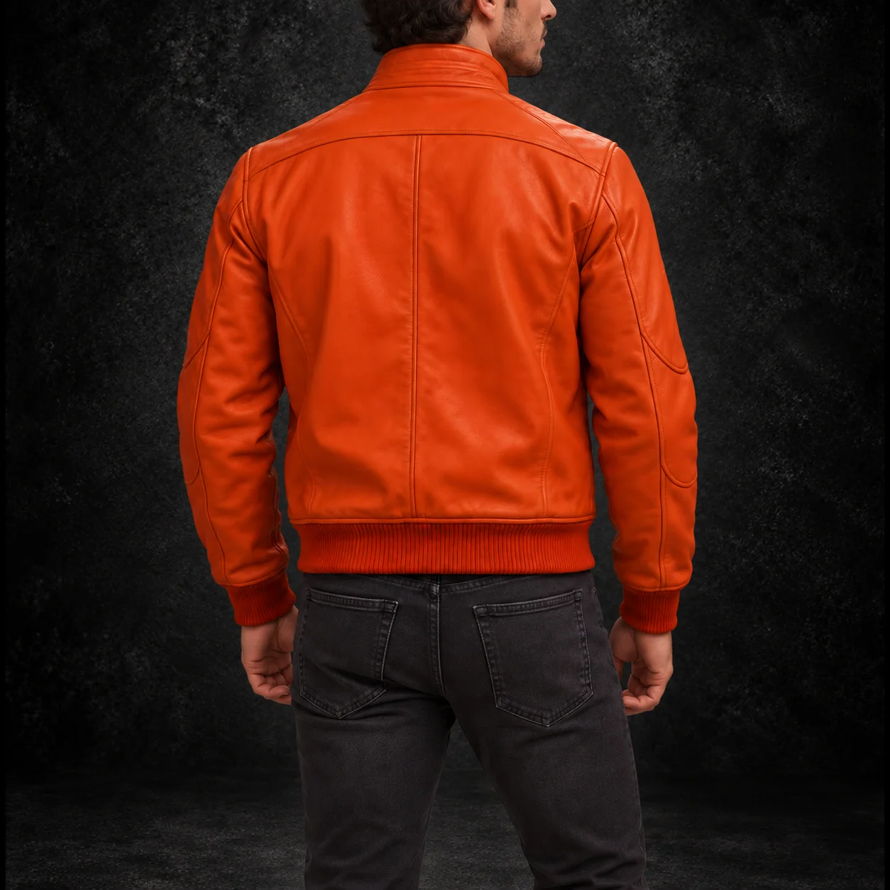 Back view showing the fit of a men's orange leather bomber jacket