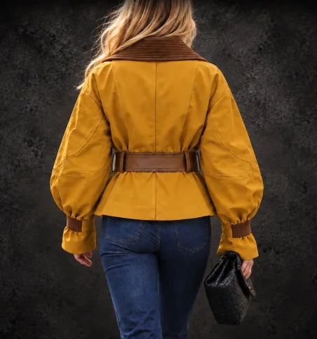 Back view of mustard belted suede jacket showing brown collar and cinched waist silhouette